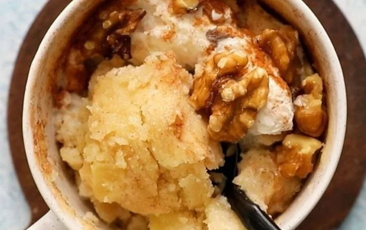 Delicious homemade Apple Mug Cake, topped with cinnamon and fresh apple slices.