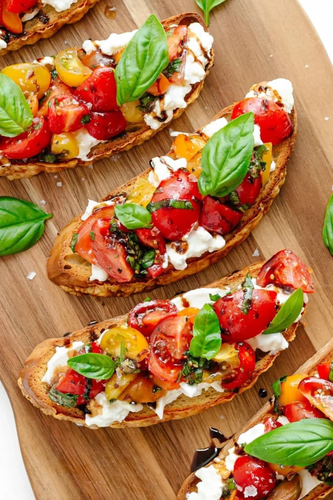 Delicious Burrata Bruschetta with tomatoes and basil on toasted bread.