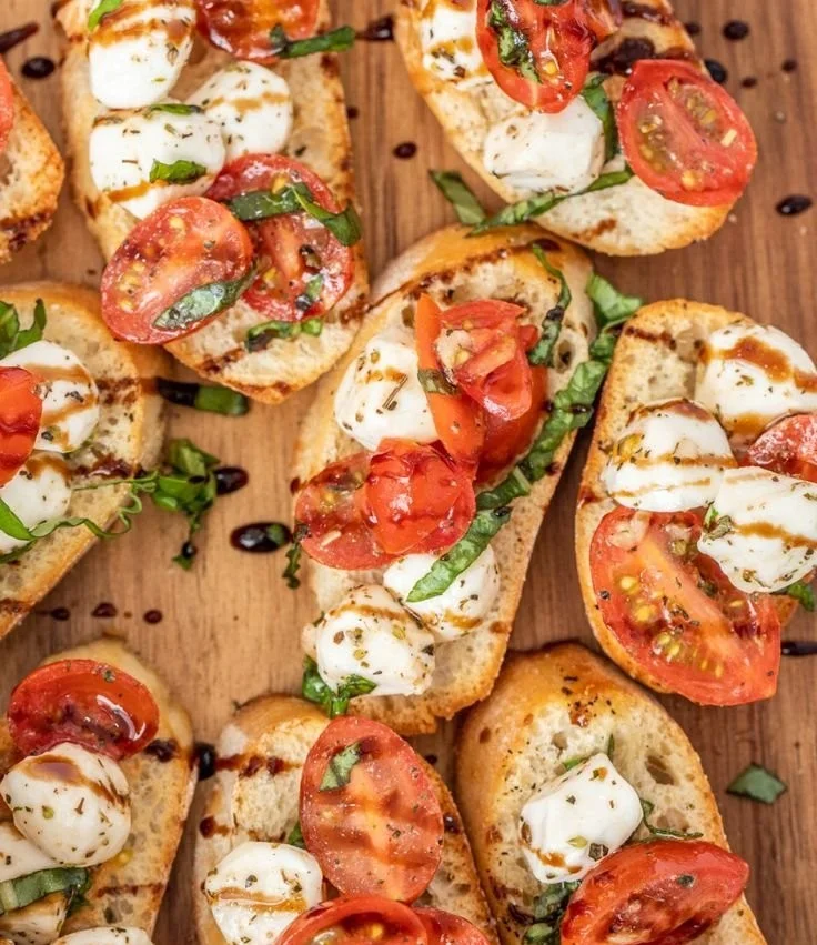 Caprese Bruschetta topped with fresh tomatoes, basil, and mozzarella cheese
