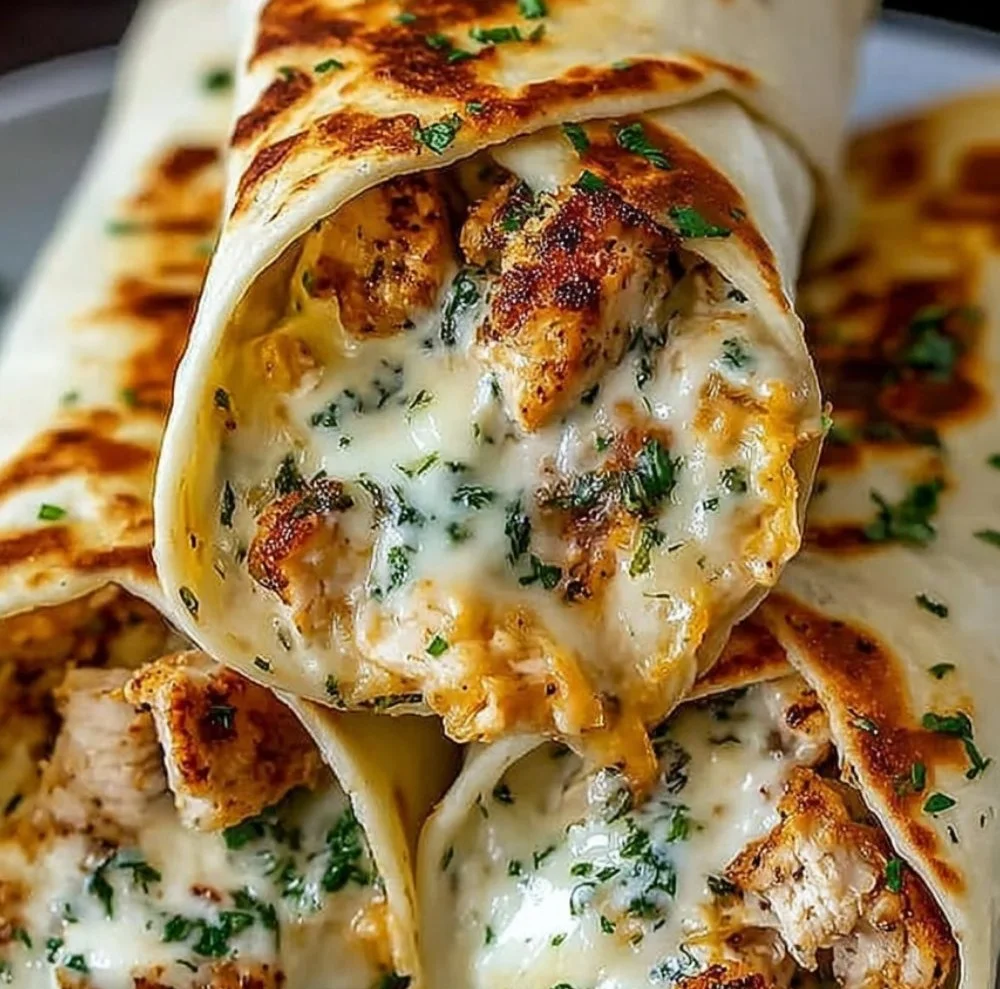 Cheesy garlic chicken wraps on a plate ready to serve