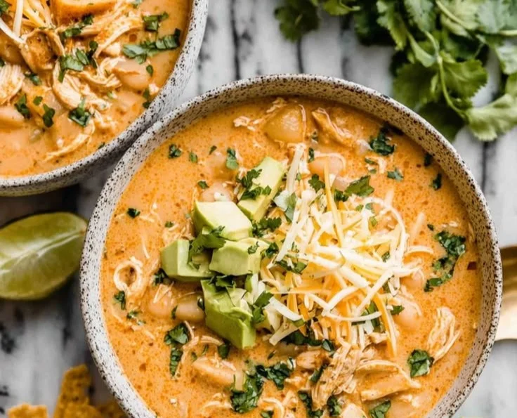 Bowl of creamy white chicken chili with toppings
