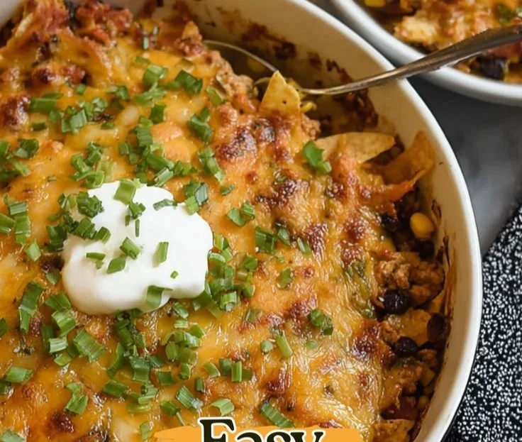Delicious Ground Chicken Taco Casserole topped with cheese and fresh ingredients.