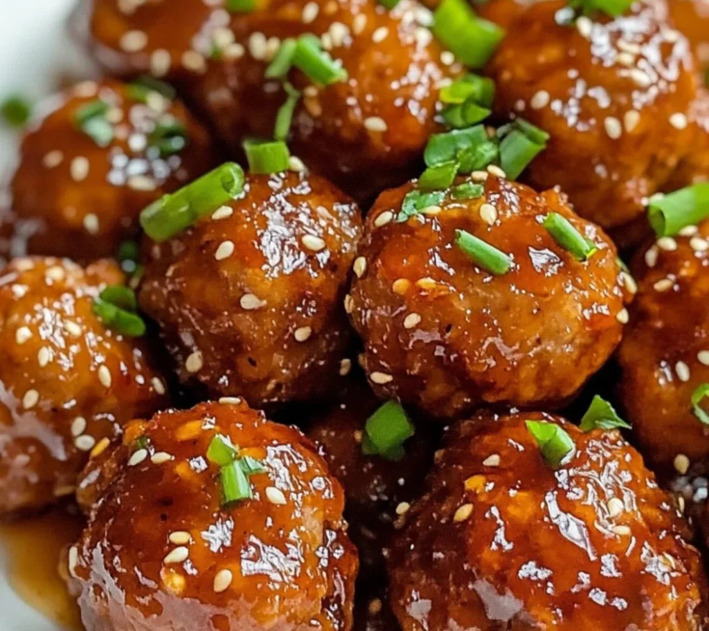 Honey garlic turkey meatballs served on a plate with garnish.