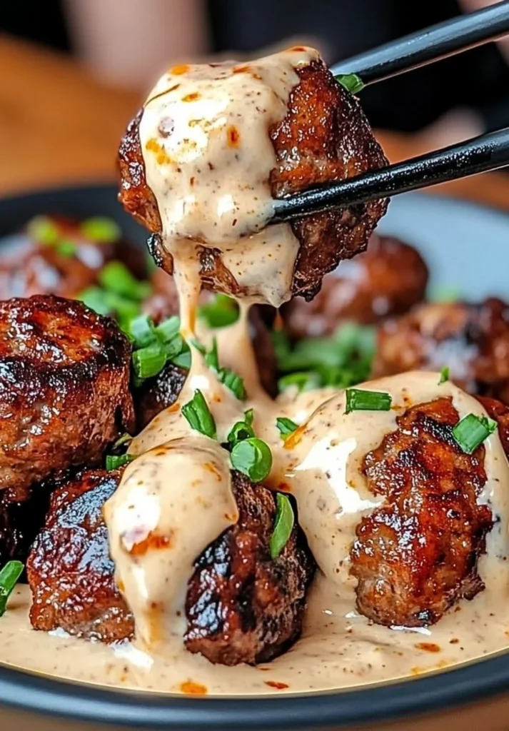 Korean BBQ Meatballs served with a spicy mayo dip on a plate