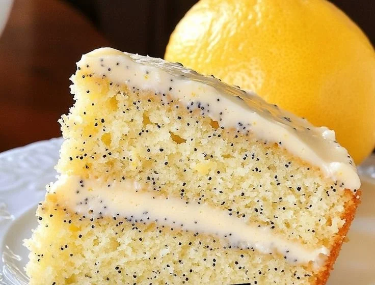 A delicious slice of homemade Lemon Poppy Seed Cake with vibrant lemon zest and poppy seeds.