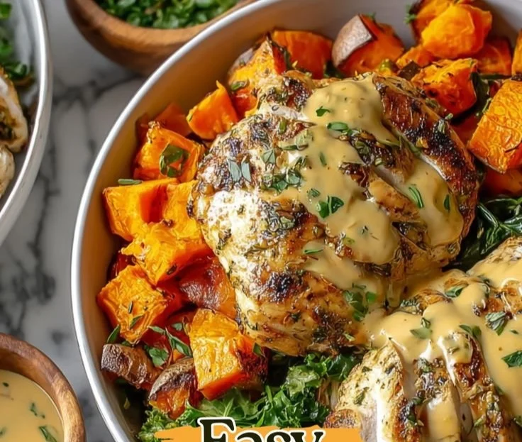 Maple Dijon Chicken served in a bowl with roasted sweet potatoes and greens.
