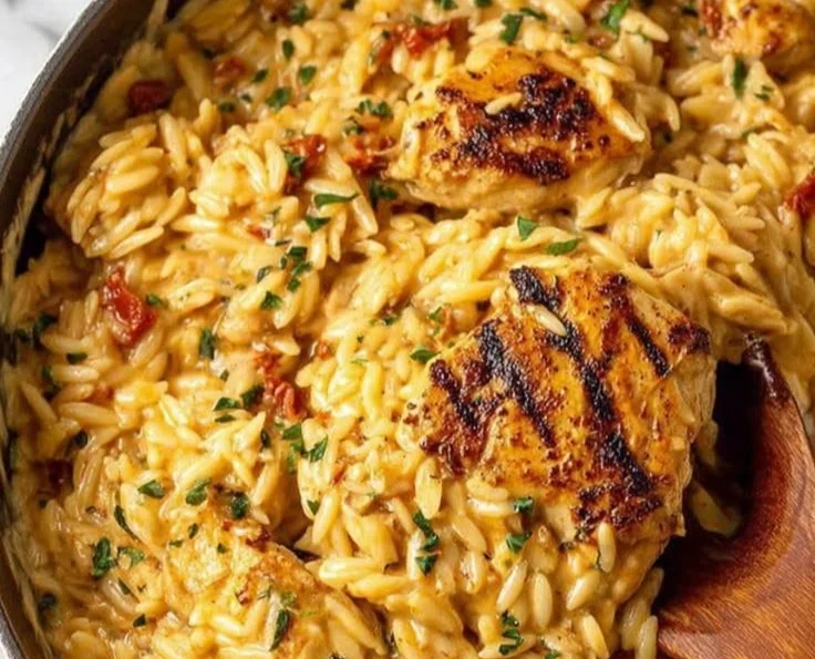 Creamy Marry Me Chicken Orzo served in a bowl with fresh herbs and vegetables