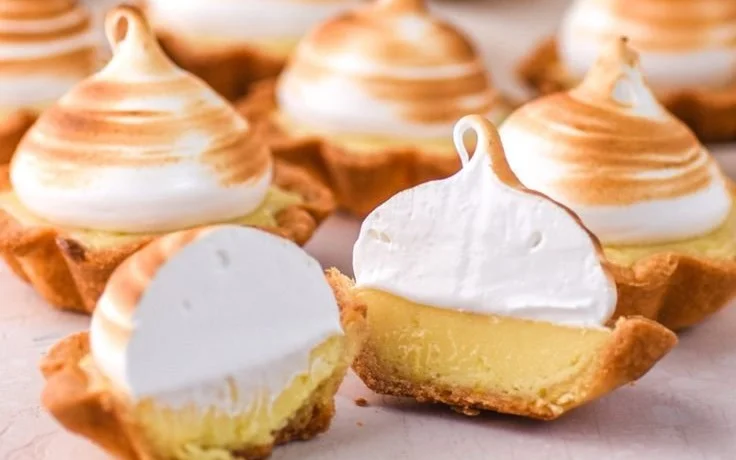 Mini lemon meringue tarts filled with lemon curd and topped with fluffy meringue.