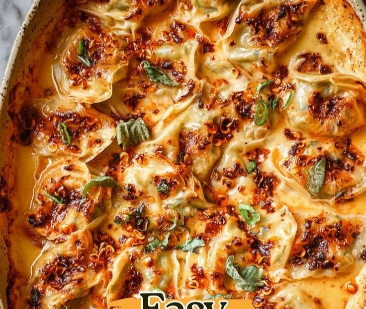 One pan baked dumplings served on a plate with dipping sauce.