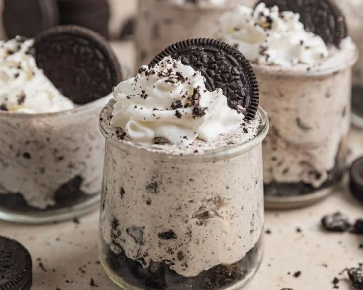 Oreo no-bake cheesecake cups topped with Oreo crumbs and whipped cream