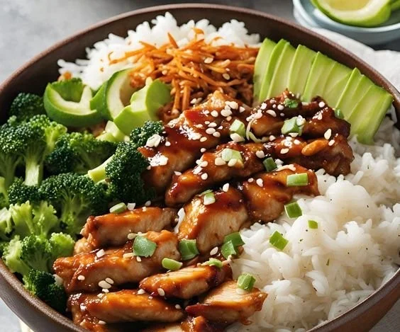 Sticky chicken rice bowls garnished with fresh herbs and vegetables.