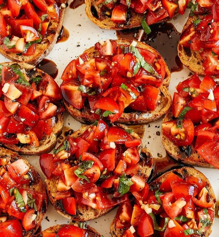 Easiest Tomato Bruschetta with basil on toasted bread.