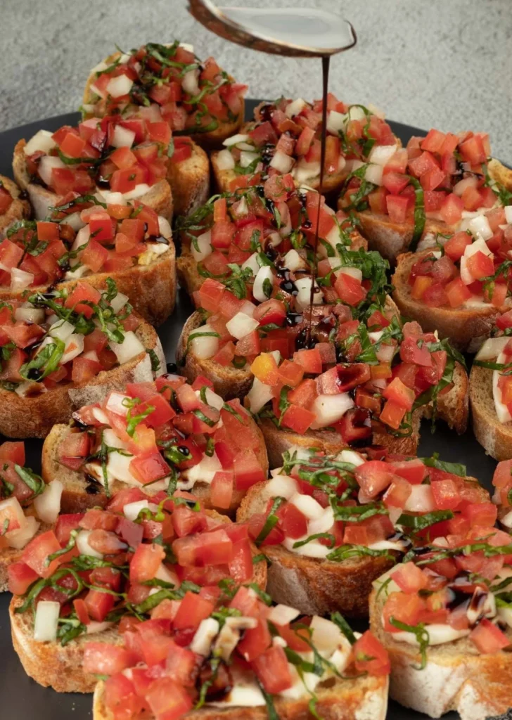 Delicious Tomato Bruschetta served on toasted bread topped with fresh ingredients.