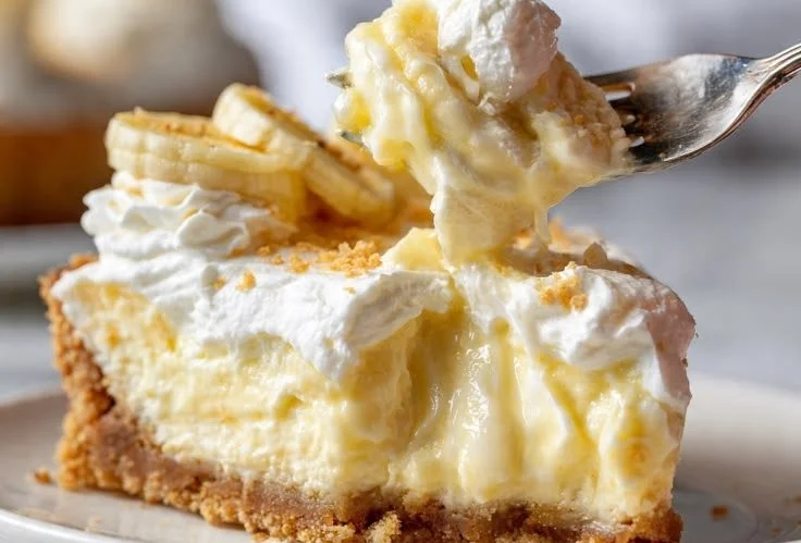 Delicious Banana Pudding Cheesecake topped with whipped cream and banana slices