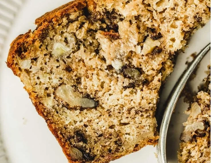 Delicious banana walnut bread fresh out of the oven with walnuts and ripe bananas