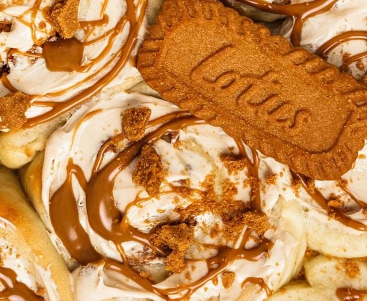 Decadent Biscoff Cinnamon Rolls topped with creamy frosting and cinnamon sugar