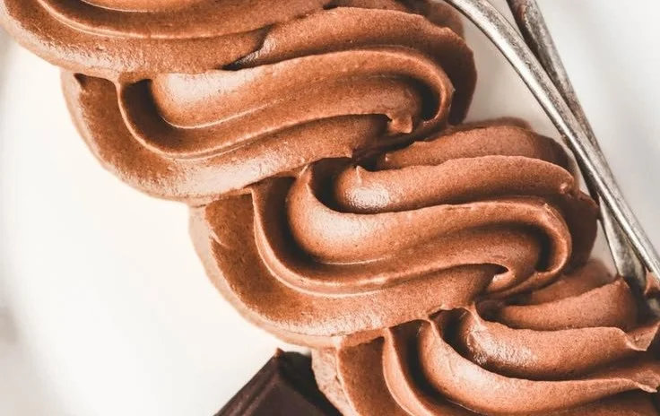Delicious Chocolate Buttercream frosting spread on a chocolate cake