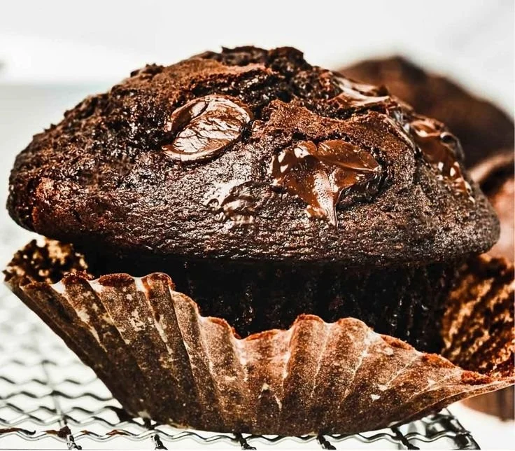 Delicious homemade chocolate muffins with a rich texture and chocolate chips.