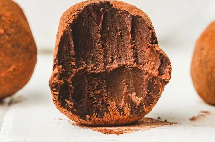 Delicious handmade chocolate truffles arranged on a plate.