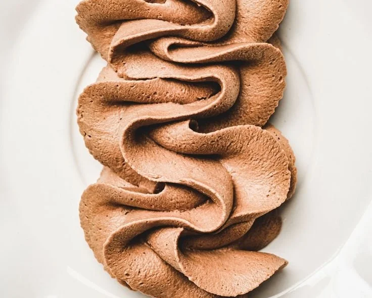 Delicious chocolate whipped cream frosting on a cake