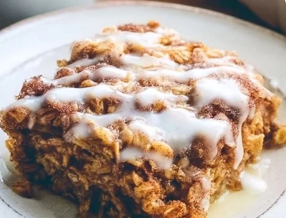 Delicious cinnamon roll baked oatmeal served in a bowl with toppings