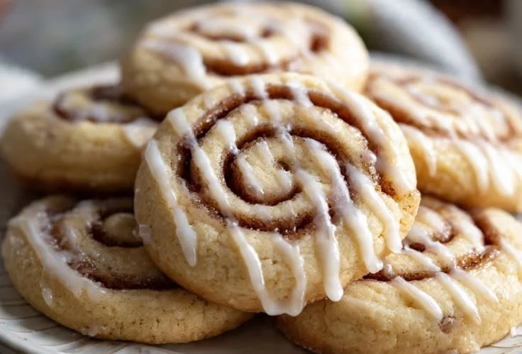 Freshly baked cinnamon roll cookies on a cooling rack