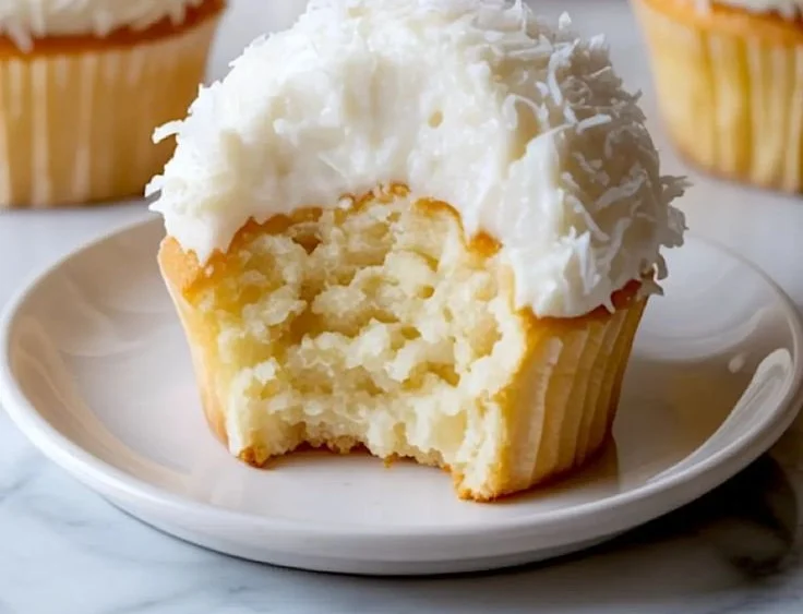 Delicious Coconut Snowball Cupcakes with coconut frosting and toppings