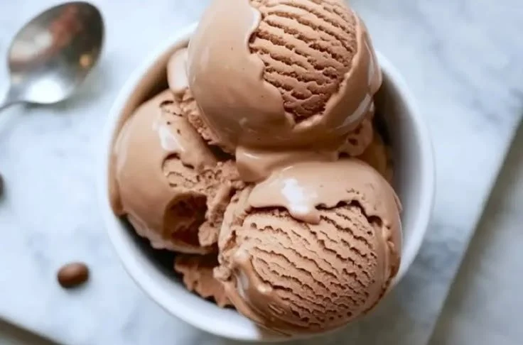 Delicious coffee ice cream served in a bowl with a spoon