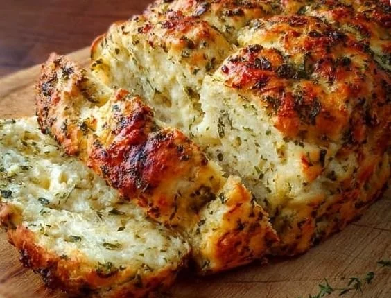 Freshly baked Italian Herb Cheese Bread on a wooden surface