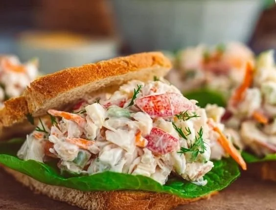 Delicious crab salad sandwich garnished with lettuce and tomato