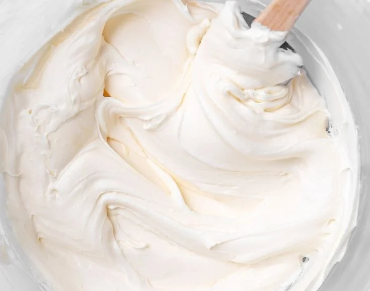 Delicious cream cheese frosting spread on a layered cake