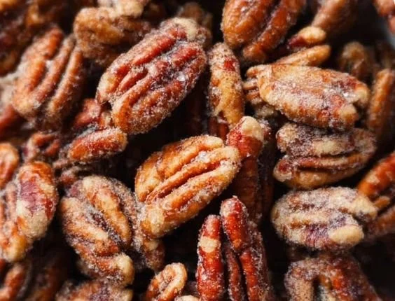 Bowl of easy candied pecans, perfect for snacks and desserts.