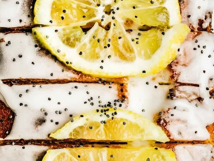 Slice of easy lemon poppy seed cake with a lemon glaze on top.
