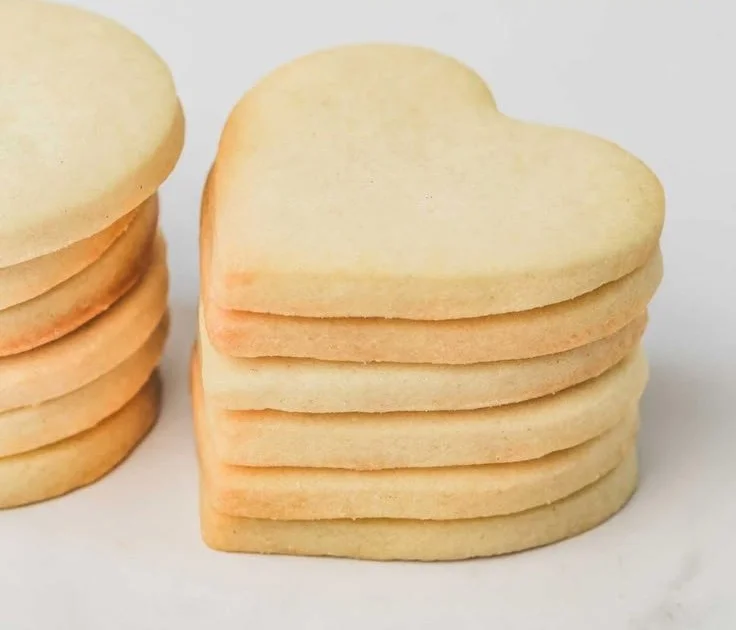 Baked easy sugar cookies on a cooling rack, ready to be decorated.