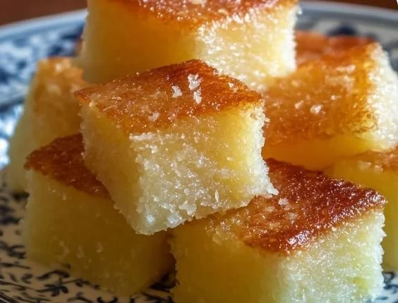 Delicious Hawaiian butter mochi squares on a plate, highlighting their chewy texture.