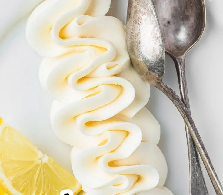 Lemon buttercream frosting on a vanilla cake slice