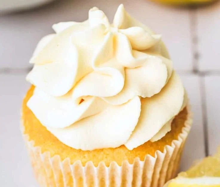 Lemon cream cheese frosting on a freshly baked cake