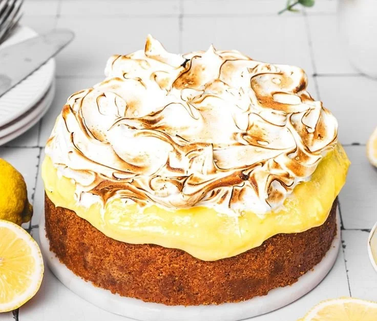 Slice of Lemon Meringue Cheesecake with creamy filling and toasted meringue topping