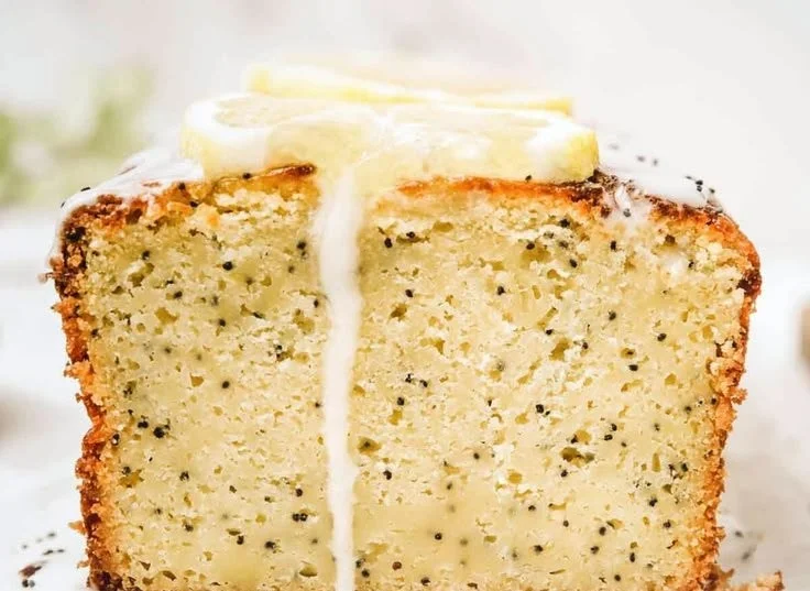 Delicious Lemon Poppy Seed Pound Cake sliced on a wooden table