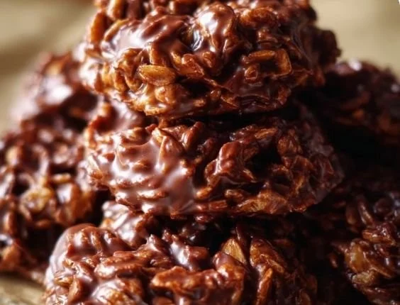 Delicious no-bake cookies arranged on a plate with chocolate drizzle.