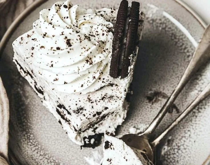 No-Bake Oreo Cheesecake topped with crushed Oreos and whipped cream