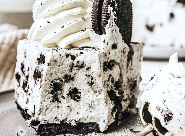 Delicious No-Bake Oreo Cheesecake topped with Oreo crumbles.