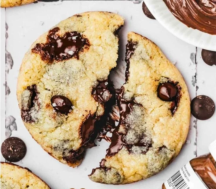 Nutella stuffed chocolate chip cookies on a plate, featuring gooey chocolate center