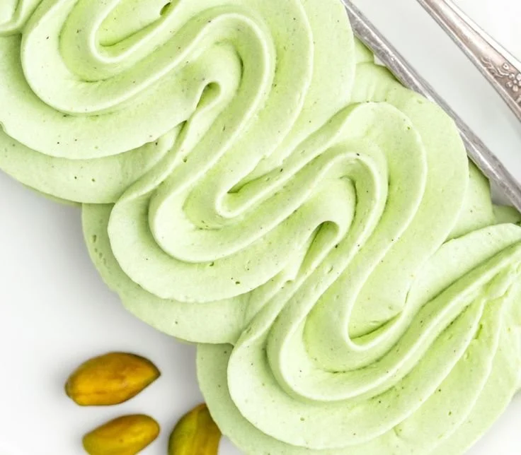 Delicious pistachio mascarpone frosting topping a cake
