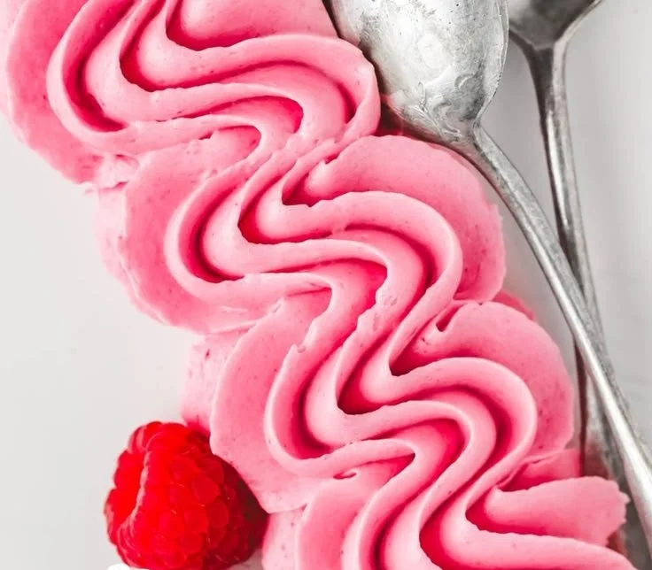 Delicious raspberry buttercream frosting on cupcakes