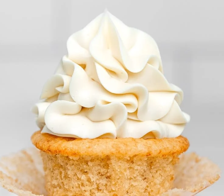 A bowl of Swiss Meringue Buttercream ready to frost delicious desserts.