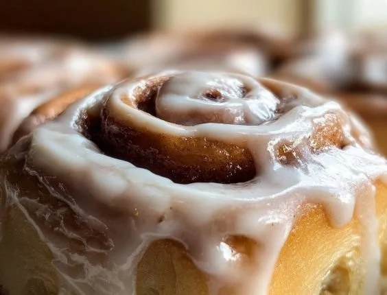 Delicious cinnamon roll icing drizzled over warm cinnamon rolls.