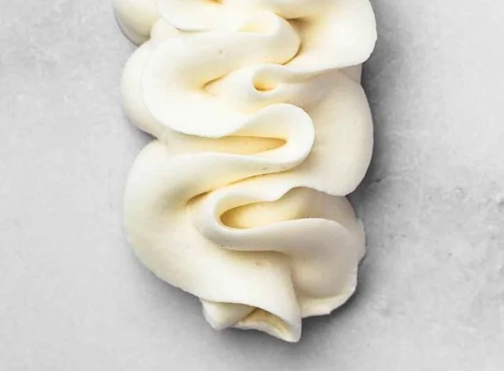 Delicious ultimate buttercream frosting on a freshly decorated cake