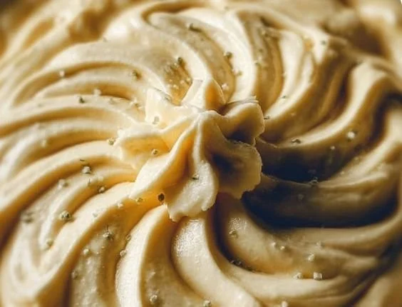 Creamy vegan cashew cheese sauce in a bowl with herbs and spices