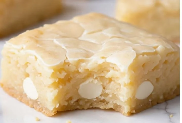 Delicious homemade white chocolate brownies topped with white chocolate chips